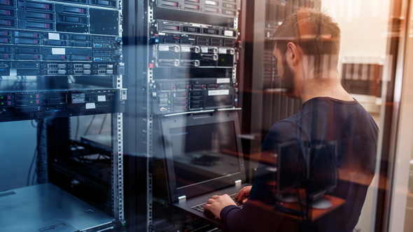 cabling and data engineer working on connections in server data room